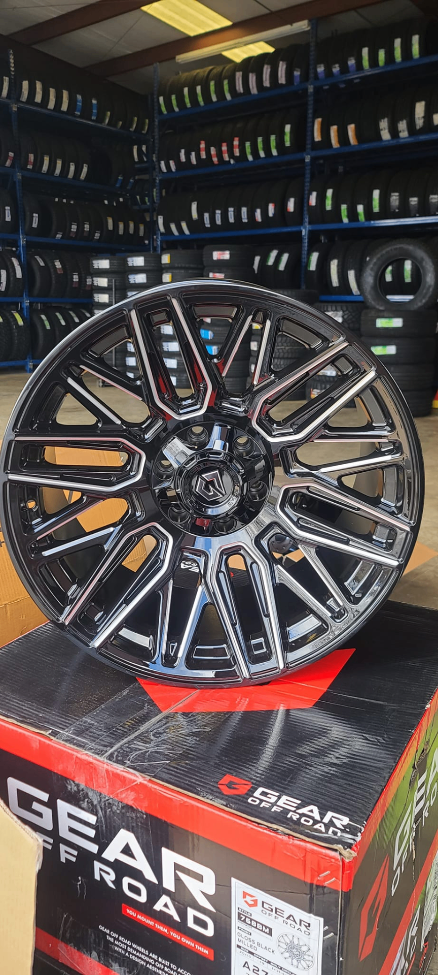 Machined black Gear Off Road wheel on display