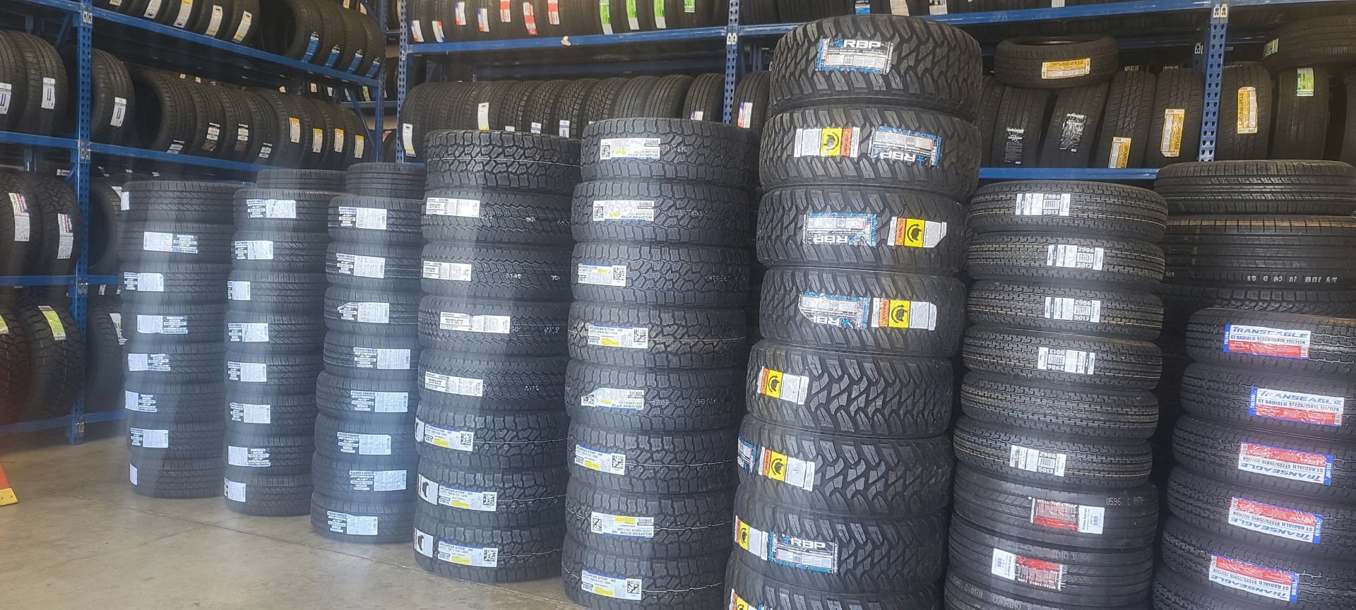 Warehouse stacked with name-brand tires